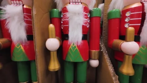 Wooden nutcracker figurines are displayed in a shopping center aisle. Video stock 323876249
