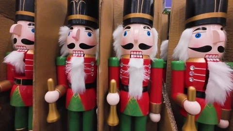 Wooden nutcracker figurines are displayed in a shopping center aisle. Stock Footage 323876313