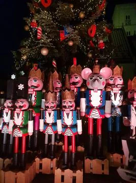 Wooden nutcracker statues standing in a row as a Christmas decoration, night Stock Photos
