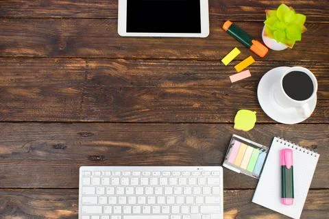 Wooden office table with computer, pen and a cup of coffee, lot of things. To Stock Photos