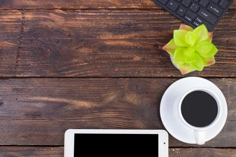 Wooden office table with computer, pen and a cup of coffee, lot of things. .. Stock Photos