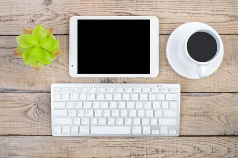Wooden office table with computer, pen and a cup of coffee, lot of things. .. Stock Photos