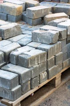A wooden pallet that is filled with multiple bricks on a construction site Stock Photos