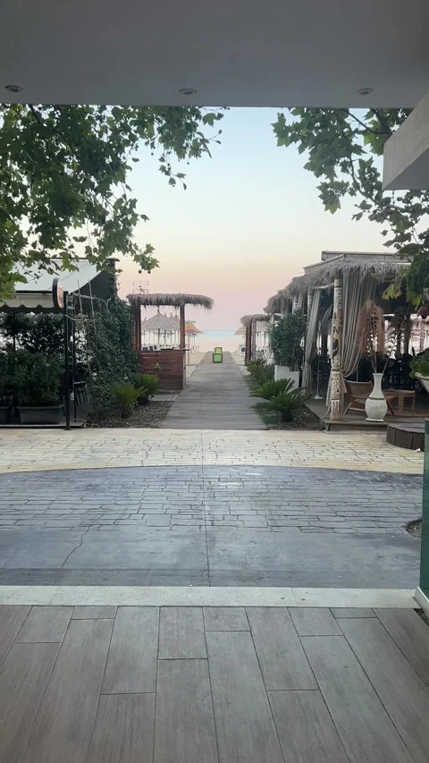 Wooden Path Through Beach Resort Lounge at Sunrise in Golem Albania Vidéo 343392205
