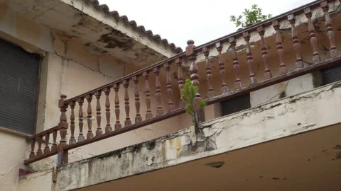 Wooden patterned balcony railing of an old abandoned house with fungus and mo Stock Footage 132667471