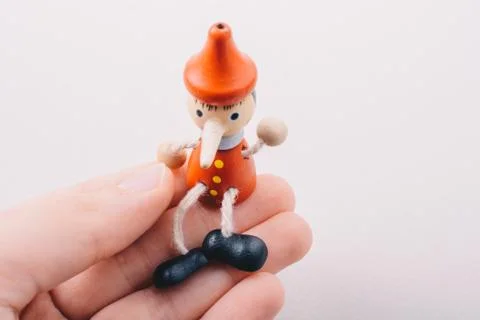Wooden pinocchio doll with his long nose Stock Photos