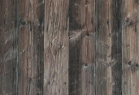 Wooden planks arranged in a vertical pattern show natural grain and texture Stock Photos