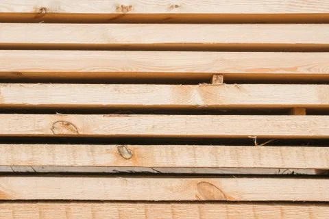 Wooden planks to build a house on a stack of folded construction base Stock Photos