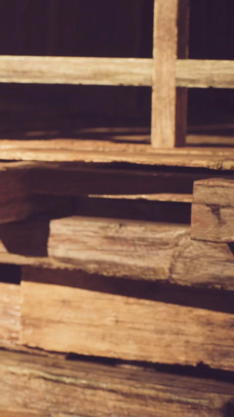Wooden planks stacked in a rustic setting during daylight hours Stock Footage 339773359