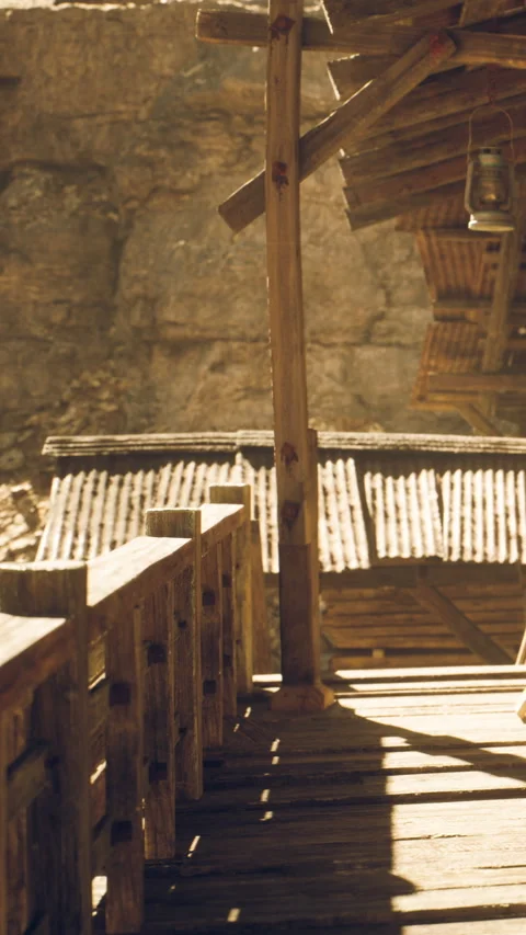 Wooden platform beside rustic buildings in a mining area during daytime Stock Footage 339040658