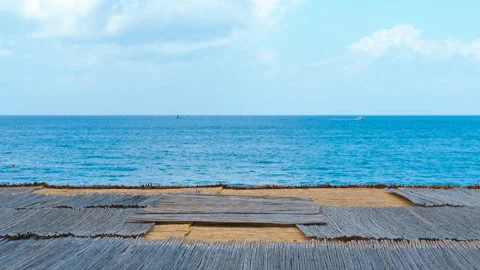 Wooden platform overlooking tranquil ocean on sunny day Stock Footage 296352800