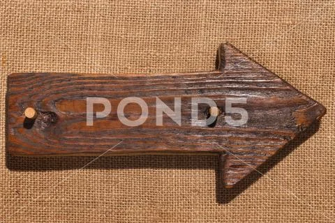 Wooden pointer made of dark wood with wooden gag and with a place for your te Stock Photos
