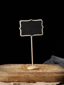 Wooden pointer on a stick for writing text, black background wooden pointe... Stock Photos