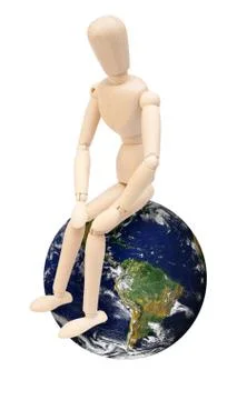 Wooden puppet on globe Stock Photos