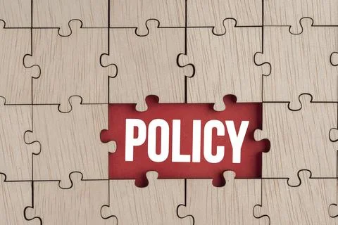 Wooden puzzle with the word policy. basic concepts or organizational policies 스톡 사진