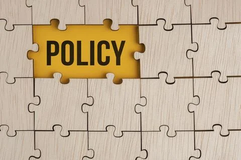 Wooden puzzle with the word policy. basic concepts or organizational policies Фото