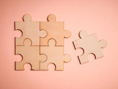 Wooden puzzles jigsaw solving problems in business. Innovation and teamwork i Stock Photos