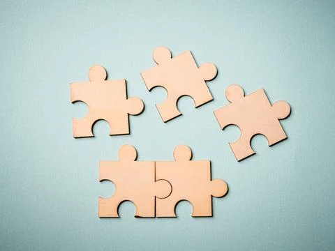 Wooden puzzles jigsaw solving problems in business. Innovation and teamwork i Stock Photos