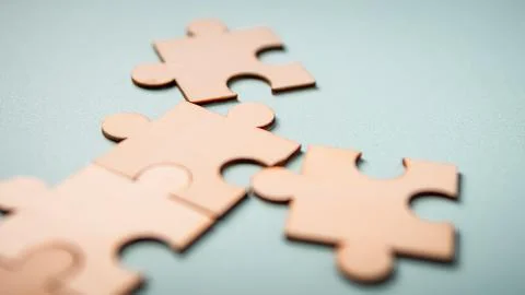Wooden puzzles jigsaw solving problems in business. Innovation and teamwork i Stock Photos