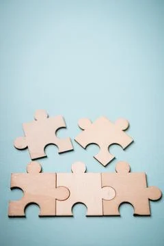 Wooden puzzles jigsaw solving problems in business. Innovation and teamwork i Stock Photos