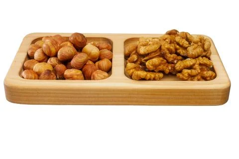 Wooden rack with assorted shelled nuts isolated on white background. Useful nuts Stockfoto's