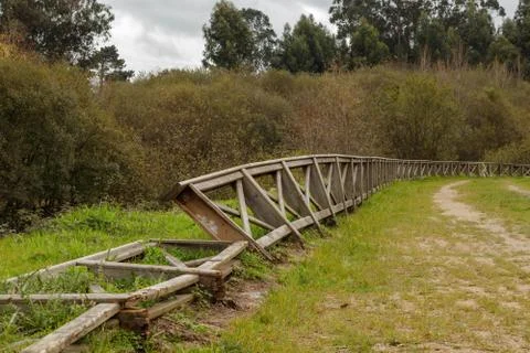 Wooden railing damaged by storms and vandals in a park in Galicia Spain Stock Photos