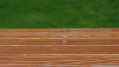 Wooden rectangular bars for construction against the background of green lawn Stockbeeldmateriaal 219954482