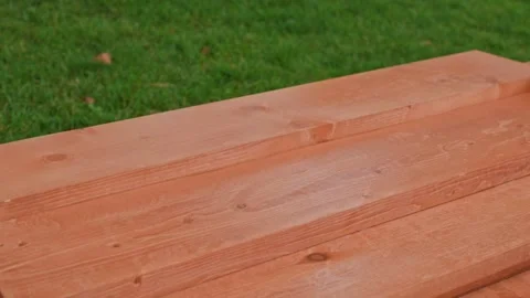 Wooden rectangular bars for construction against the background of green lawn Stockbeeldmateriaal 219954547