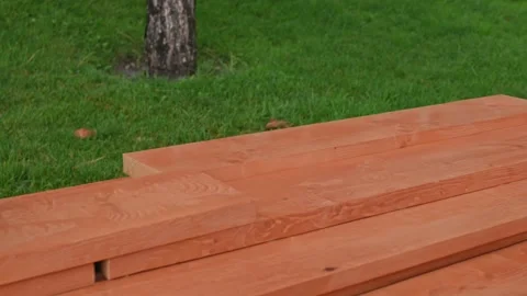 Wooden rectangular bars for construction against the background of green lawn Stockbeeldmateriaal 220721791