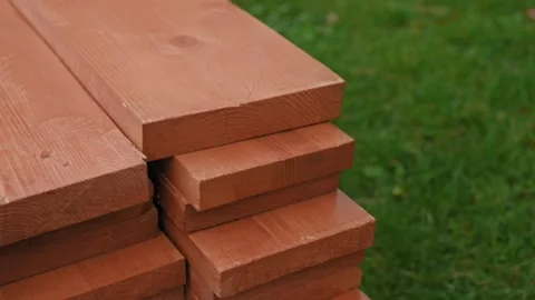 Wooden rectangular bars for construction against the background of green lawn Видео 220721914