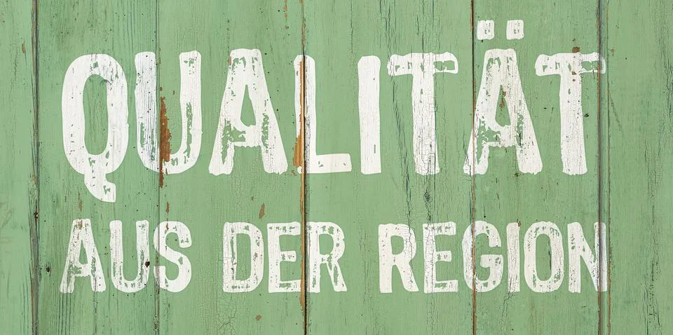 Wooden retro sign - Regional Quality in german - Qualitt aus der Region Stock Photos