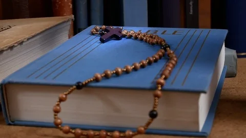 Wooden Rosary on the Bible. Zoom in. Stock Footage