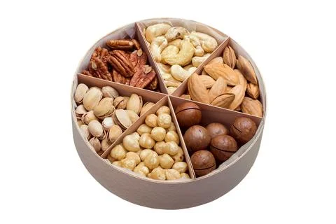 Wooden round gift dish with triangular cells and mix of different types. Stock Photos