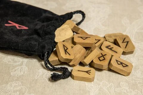 Wooden runes with bag. Stock Photos