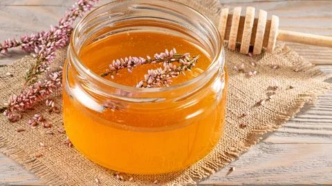 Wooden rustic table setting with heather honey and honey stick - farmhouse .. Stock Photos