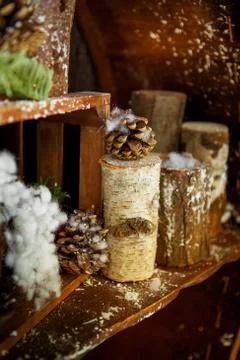 Wooden shelf with a log and pine cones. Decoration of country house for Chris Stock Photos