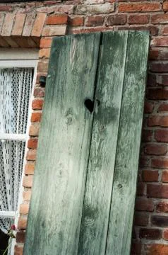 Wooden shutter on bricks wall background Stock Photos