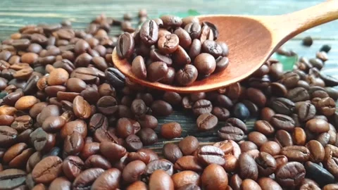 Wooden spoon coffee beans falling in slow motion Video stock 161477559