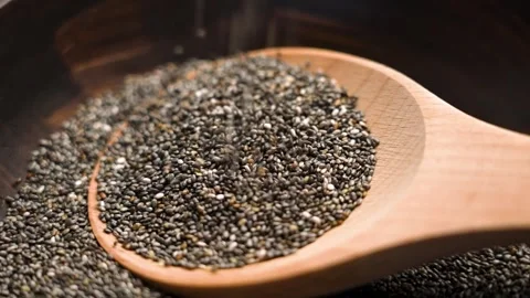 Wooden spoon with falling chia seeds. Slow motion Stock Footage 292118955