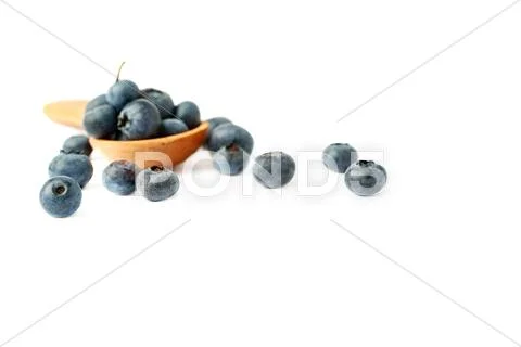 Wooden spoon filled of Bilberry or blueberry over isolated white background Stock Photos