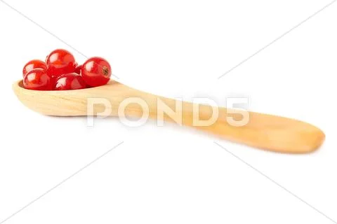 Wooden spoon filled with Red Currant isolated over white background Stock Photos