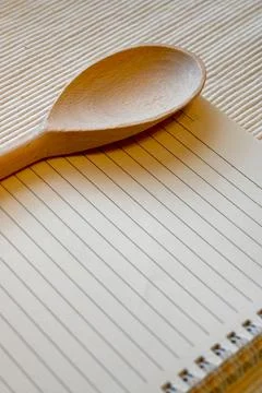 Wooden spoon on a lined notebook Stock Photos