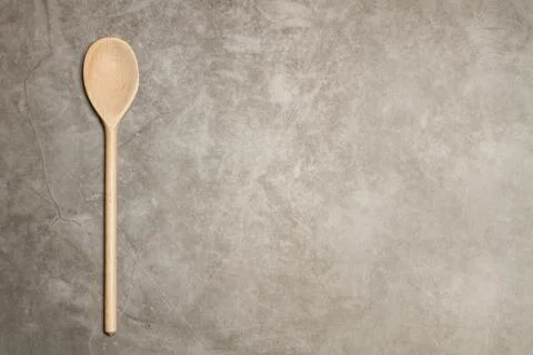 Wooden spoon with a long handle on a marble table Stock Photos