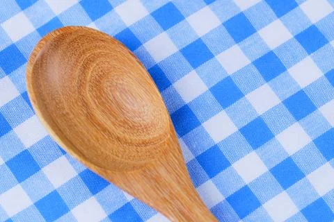 Wooden spoon,  tablecloth, fork on table background Stock Photos