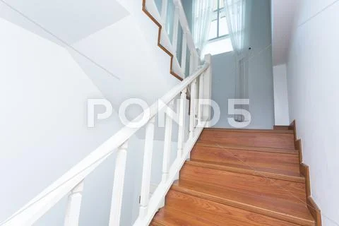 Wooden staircase made from laminate wood in white modern house Stock Photos