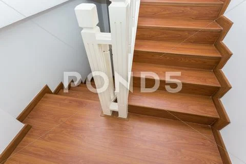 Wooden staircase made from laminate wood in white modern house Stock Photos
