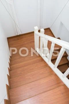 Wooden staircase made from laminate wood in white modern house Stock Photos