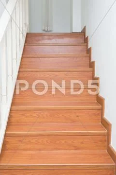 Wooden staircase made from laminate wood in white modern house Stock Photos