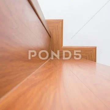Wooden staircase made from laminate wood in white modern house Stock Photos