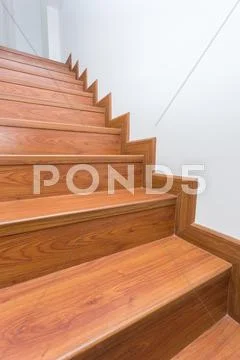 Wooden staircase made from laminate wood in white modern house Stock Photos